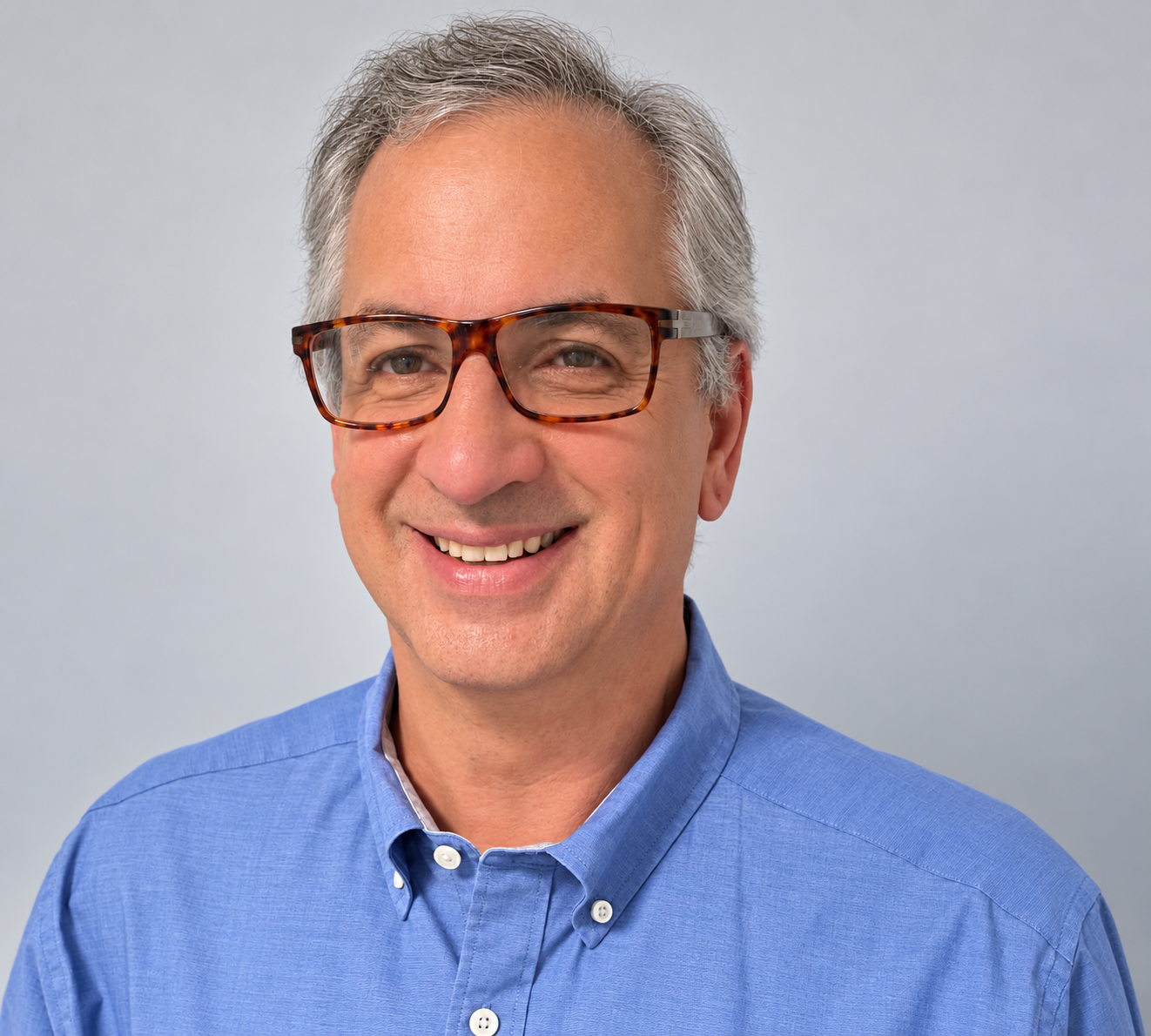Luc Samson smiling in a blue shirt